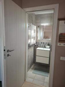 a white bathroom with a sink and a mirror at Homey Apartment Vacaresti in Bucharest +33 photos