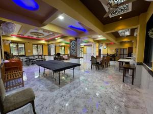a dining room with a table and chairs at Arav Resort in Katrab