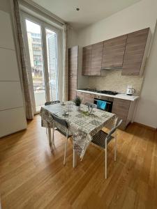 a kitchen with a table and chairs in a room at Sea House in Catania