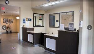 a lobby of a building with counters and a clock at Karnes City Lodge in Karnes City +33 photos
