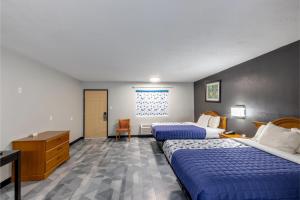 Postel nebo postele na pokoji v ubytování Freer Executive inn and Studios