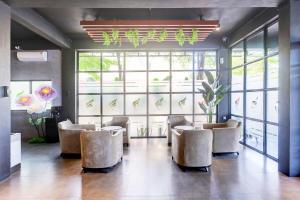 a waiting room with chairs and large windows at Collection O Near UNRIKA Formerly Dory Inn in Sekupang