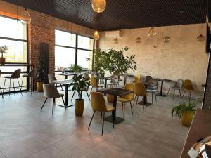a restaurant with tables and chairs in a room at Avto Spa in Khmelnytskyi