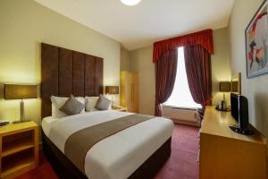 a hotel room with a large bed and a window at Highland Aberdeen City Centre in Aberdeen