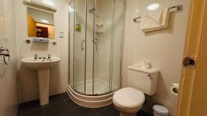 a bathroom with a shower and a toilet and a sink at Highland Aberdeen City Centre in Aberdeen