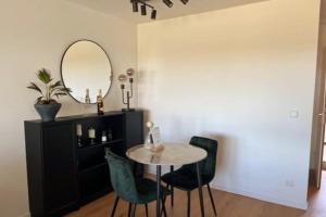 a dining room with a table and chairs and a mirror at Apartment mit Grüner Aussicht im Schwarzwald in Löffingen