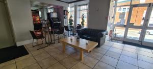 a living room with a couch and a coffee table at The Arncliff Hotel in Blackpool