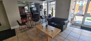 a living room with a couch and a table at The Arncliff Hotel in Blackpool