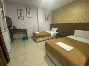 Postel nebo postele na pokoji v ubytování Hotel O Hotel Hamilas