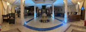 a lobby with a fountain in the middle of a building at Riad eSSAOUIRA View in Essaouira