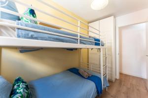 a bedroom with two bunk beds with blue sheets at Sunset House in Málaga