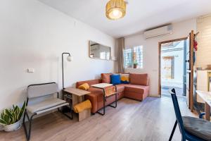 a living room with a couch and a table at Sunset House in Málaga +20 photos