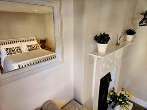 a bedroom with a bed and a mirror at The Lodge in Wadhurst