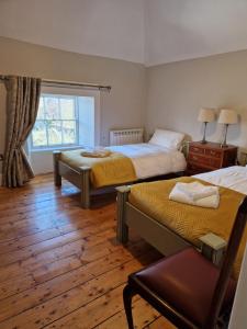a bedroom with two beds and a window at The Forum - Mountmellick - Church in Mountmellick