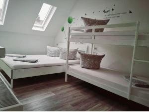 a bedroom with two bunk beds and a ladder at Ferienwohnung Jasmin in Rust