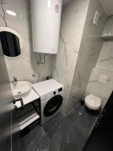 a bathroom with a washing machine and a sink at Villa paradise in Podstrana +30 photos