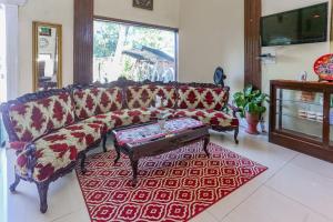 a living room with a couch and a red rug at Collection O Puncak Bogor Near Taman Safari Indonesia Formerly Hotel Andalus in Bogor +46 photos