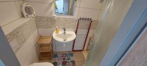 a small bathroom with a sink and a window at Penzion-Na Navsi in Horní Planá +60 photos