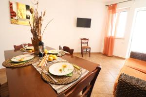 a dining room table with plates of food on it at Casa Samira Otranto Near Sea and Old Town AC, WiFi, 4 Guests in Otranto