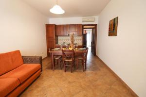 a living room with a couch and a table at Casa Samira Otranto Near Sea and Old Town AC, WiFi, 4 Guests in Otranto