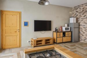 a kitchen with a stove and a tv on the wall at Mondello's Pearl in Mondello