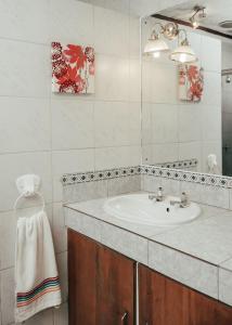 a bathroom with a sink and a mirror at Letona Guesthouse in Kuruman