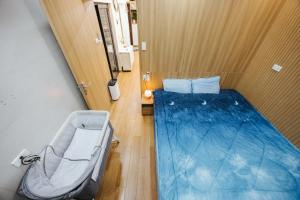 a small room with a bed and a chair at Yuzu Home Hang Voi in Hanoi +210 photos