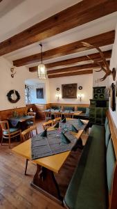 a dining room with wooden tables and chairs at Schlosshotel Harburg in Harburg