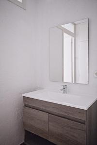 a bathroom with a white sink and a mirror at Calafate 4 in L'Ametlla de Mar +25 photos