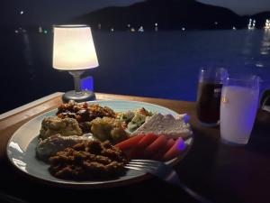 a plate of food with meat and vegetables on a table at Selimiye Çapkını in Marmaris