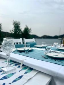 a table with a blue and white table set with plates and glasses at Selimiye Çapkını in Marmaris +24 photos