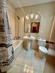 a bathroom with a toilet and a sink and a tub at Apartamento de vistabella REF 015 in Vistabella del Maestrazgo +15 photos