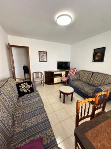 a living room with a couch and a tv at Apartamento de vistabella REF 015 in Vistabella del Maestrazgo
