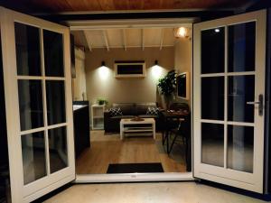 an open door to a living room with a couch at Park De Driesprong in Nieuwveen
