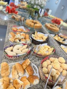 a buffet with many different types of bread and pastries at Big Hotel in Imperatriz