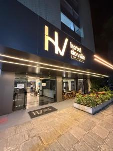 a building with a sign on the side of it at Hotel do Vale in Campina Grande