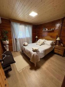 a bedroom with a large bed and a window at La CABAÑA in Candeleda +20 photos
