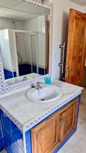 a bathroom with a sink and a mirror at La Manga Club Villa in Atamaría