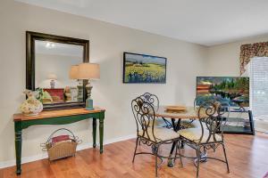 a dining room with a table and chairs and a mirror at Lagoon Villas 13 by Wild Dunes, with Amenities in Isle of Palms