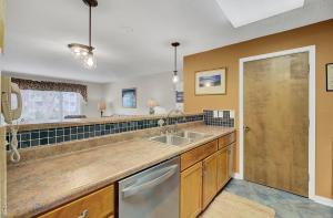 a large kitchen with a sink and a window at Lagoon Villas 13 by Wild Dunes, with Amenities in Isle of Palms