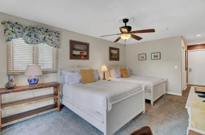 a bedroom with two beds and a ceiling fan at Lagoon Villas 13 by Wild Dunes, with Amenities in Isle of Palms