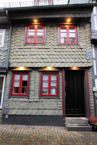 a house with red windows and a black door at Ferienhaus Charlotte in Goslar