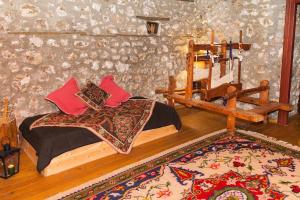 a bedroom with a bed in a room with a rug at 260m2 Unique mountain house in Lilea Parnasos in Lílaia