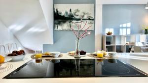 a kitchen with a table with a vase of flowers at CASA LOS ABETOS cerca de la Alhambra y Sierra Nevada in Cenes de la Vega