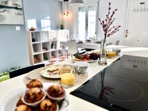 a table with plates of food and glasses of orange juice at CASA LOS ABETOS cerca de la Alhambra y Sierra Nevada in Cenes de la Vega +66 photos