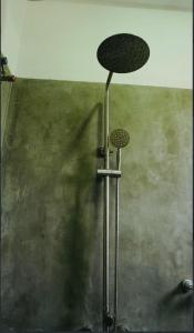 a shower with a shower cap on a wall at Blue Beach Ahangama in Ahangama