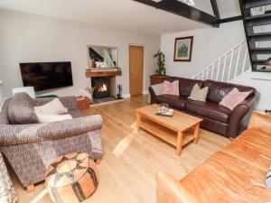 a living room with a couch and a coffee table at Old Stable Cottage in Alnmouth