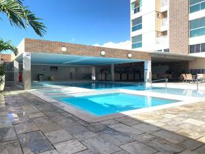 a swimming pool in front of a building at Hotel Piazza diRoma com acesso ao Acqua Park e Splash in Caldas Novas