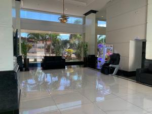 a living room with a large white tile floor at Hotel Piazza diRoma com acesso ao Acqua Park e Splash in Caldas Novas +22 photos