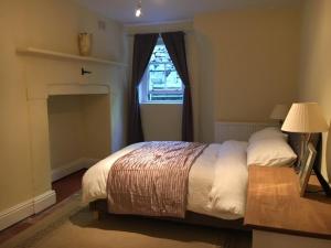 a bedroom with a bed and a window at Garden View in Great Malvern